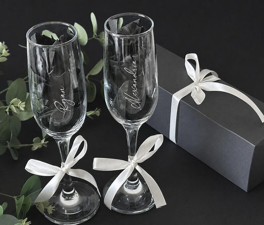 Personalized name champagne flutes shown with gift packaging
