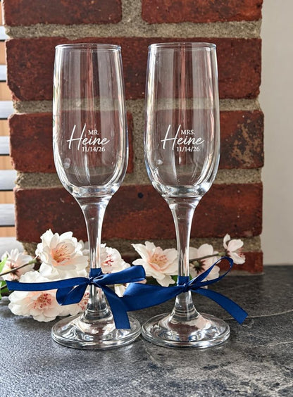 Mr and Mrs champagne flutes with navy blue ribbons