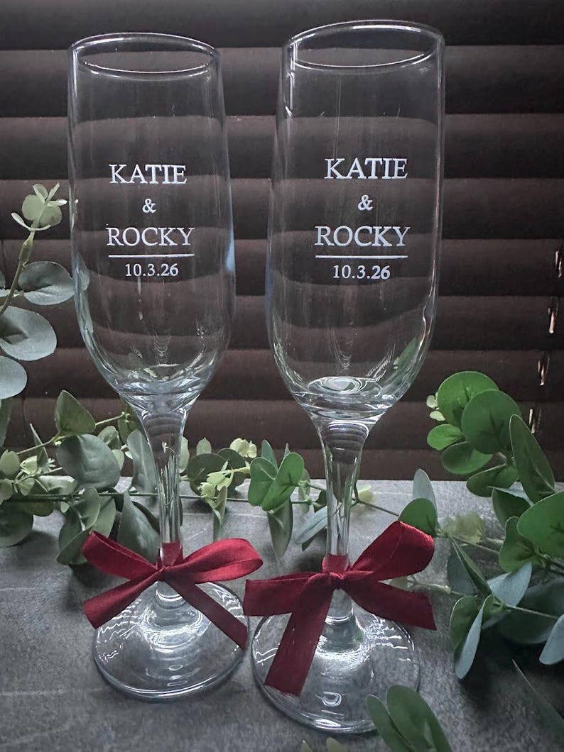 Engraved wedding champagne flutes with names, date and burgundy ribbons