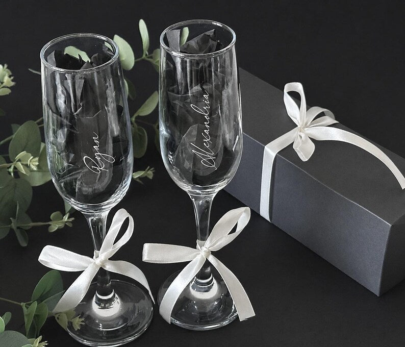 Personalized name champagne flutes shown with gift packaging