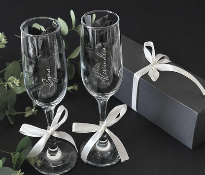 Personalized name champagne flutes shown with gift packaging