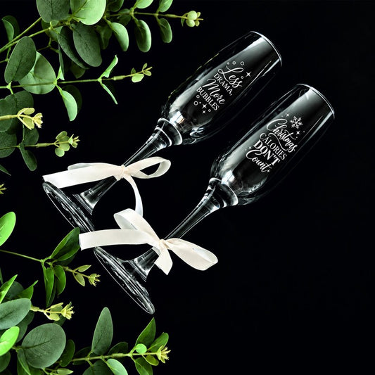 Funny and Christmas engraved champagne flutes shown as a pair